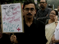 Artist professionals shout slogans and hold placards as part of a protest against the rape and murder of a trainee medic at a government-run...