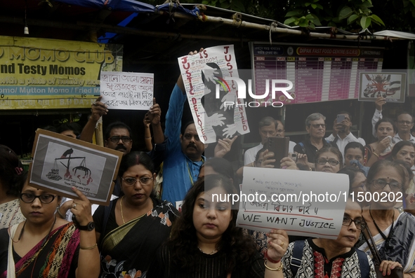 Artist professionals shout slogans and hold placards as part of a protest against the rape and murder of a trainee medic at a government-run...