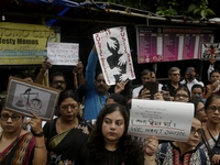 Artist professionals shout slogans and hold placards as part of a protest against the rape and murder of a trainee medic at a government-run...