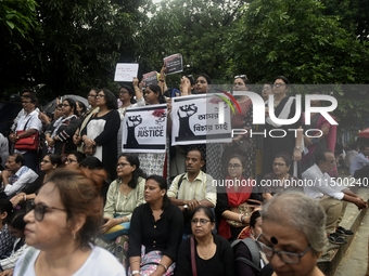 Artist professionals shout slogans and hold placards as part of a protest against the rape and murder of a trainee medic at a government-run...