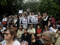 Artist professionals shout slogans and hold placards as part of a protest against the rape and murder of a trainee medic at a government-run...