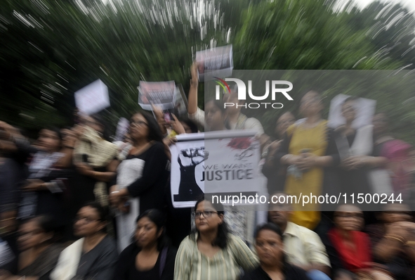 Artist professionals shout slogans and hold placards as part of a protest against the rape and murder of a trainee medic at a government-run...