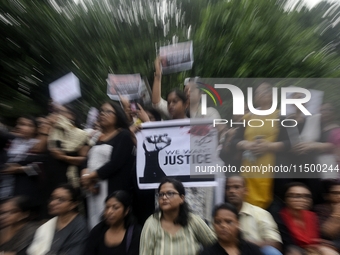 Artist professionals shout slogans and hold placards as part of a protest against the rape and murder of a trainee medic at a government-run...