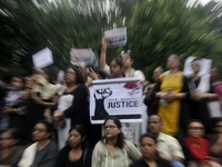 Artist professionals shout slogans and hold placards as part of a protest against the rape and murder of a trainee medic at a government-run...