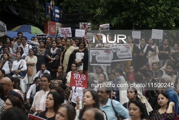 Artist professionals shout slogans and hold placards as part of a protest against the rape and murder of a trainee medic at a government-run...