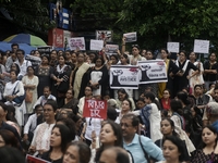 Artist professionals shout slogans and hold placards as part of a protest against the rape and murder of a trainee medic at a government-run...