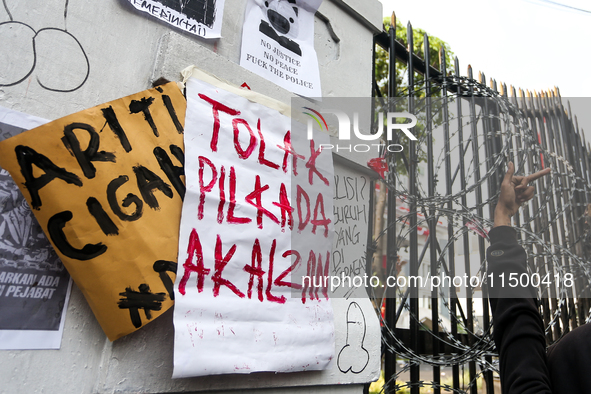 Posters reject the ratification of the Regional Head Election (Pilkada) Bill in front of the West Java DPRD Building in Bandung, Indonesia,...