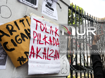 Posters reject the ratification of the Regional Head Election (Pilkada) Bill in front of the West Java DPRD Building in Bandung, Indonesia,...