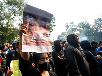 A woman holds a protest poster during a demonstration to reject the revised Regional Head Election Bill (RUU) in front of the West Java DPRD...