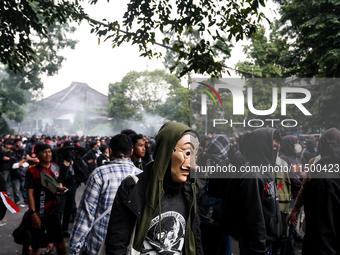 A protester wears a Money Heist mask during a protest against the revision of the Regional Head Election Bill (RUU) in front of the West Jav...