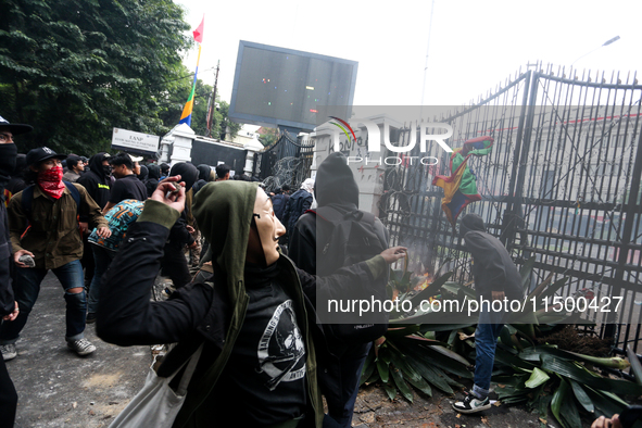 A protester wears a Money Heist mask during a protest against the revision of the Regional Head Election Bill (RUU) in front of the West Jav...