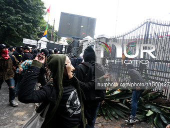 A protester wears a Money Heist mask during a protest against the revision of the Regional Head Election Bill (RUU) in front of the West Jav...