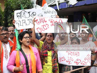 Bharatiya Janata Party (BJP) activists shout slogans during a protest rally as they go towards the State Health & Family Welfare Department...