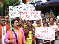 Bharatiya Janata Party (BJP) activists shout slogans during a protest rally as they go towards the State Health & Family Welfare Department...