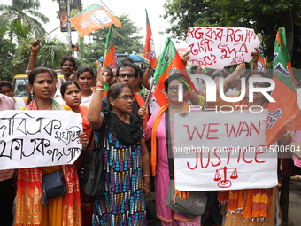 Bharatiya Janata Party (BJP) activists shout slogans during a protest rally as they go towards the State Health & Family Welfare Department...