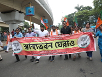 Bharatiya Janata Party (BJP) activists shout slogans after breaking the police barricade during a protest rally as they go towards the State...