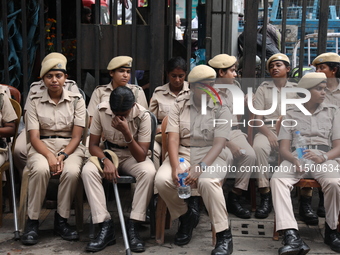 The police force sits guard inside R G Kar Medical College and Hospital while medical students protest against the rape and murder of a PGT...