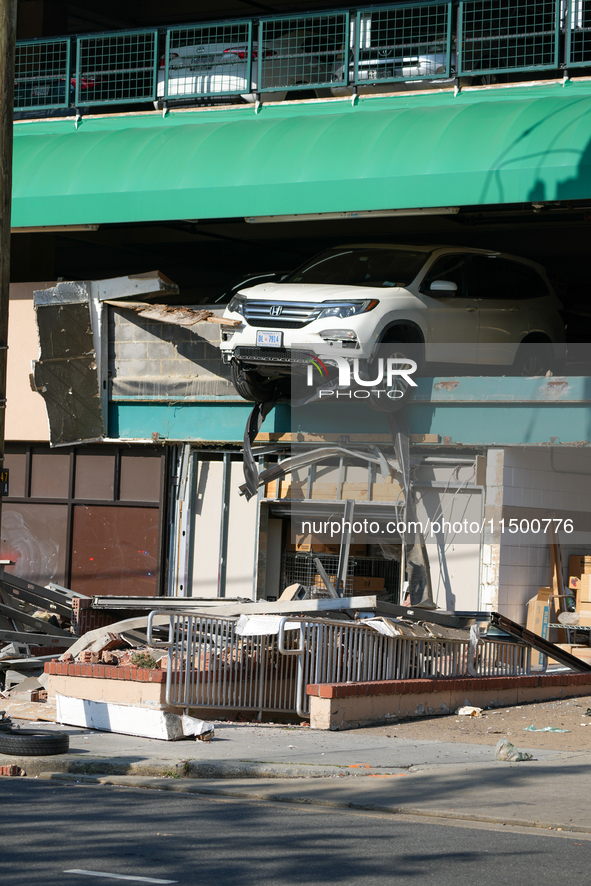 A car drives through the barrier at the Whole Foods in Tenleytown, Washington, DC, damaging the entrance to a Wawa convenience store. No one...