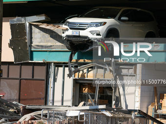 A car drives through the barrier at the Whole Foods in Tenleytown, Washington, DC, damaging the entrance to a Wawa convenience store. No one...