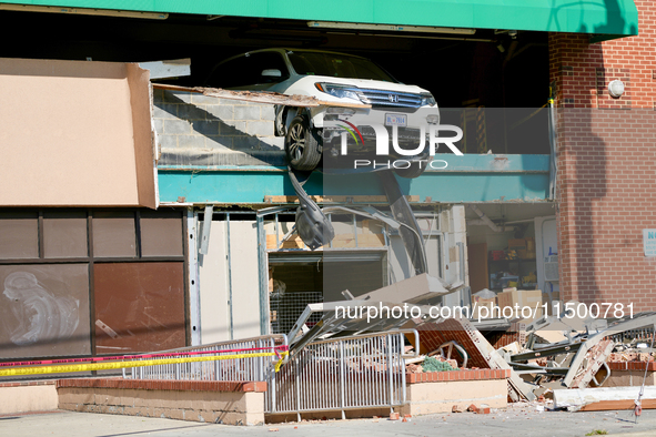 A car drives through the barrier at the Whole Foods in Tenleytown, Washington, DC, damaging the entrance to a Wawa convenience store. No one...