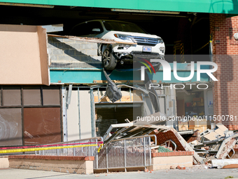 A car drives through the barrier at the Whole Foods in Tenleytown, Washington, DC, damaging the entrance to a Wawa convenience store. No one...