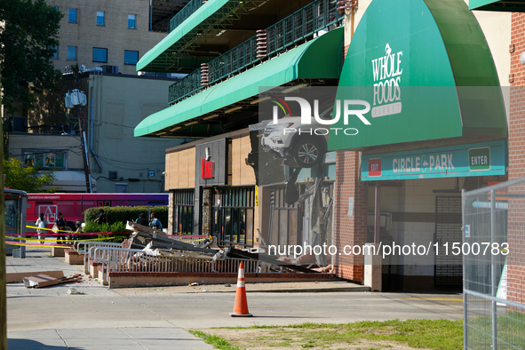 A car drives through the barrier at the Whole Foods in Tenleytown, Washington, DC, damaging the entrance to a Wawa convenience store. No one...