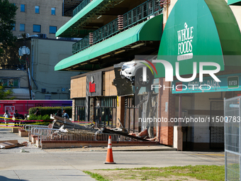 A car drives through the barrier at the Whole Foods in Tenleytown, Washington, DC, damaging the entrance to a Wawa convenience store. No one...