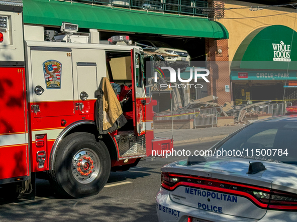 A car drives through the barrier at the Whole Foods in Tenleytown, Washington, DC, damaging the entrance to a Wawa convenience store. No one...