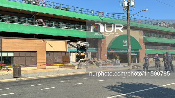 A car drives through the barrier at the Whole Foods in Tenleytown, Washington, DC, damaging the entrance to a Wawa convenience store. No one...