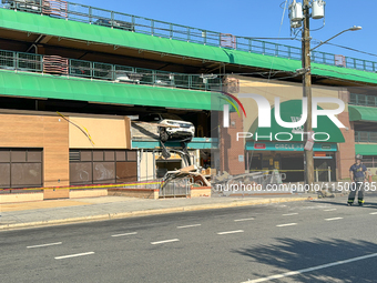 A car drives through the barrier at the Whole Foods in Tenleytown, Washington, DC, damaging the entrance to a Wawa convenience store. No one...