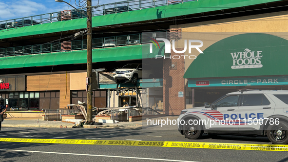 A car drives through the barrier at the Whole Foods in Tenleytown, Washington, DC, damaging the entrance to a Wawa convenience store. No one...