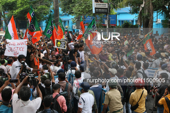 Bharatiya Janata Party (BJP) activists break the police barricade during a protest rally as they go towards the 'Swasthya Bhawan' or State H...