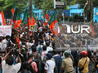 Bharatiya Janata Party (BJP) activists break the police barricade during a protest rally as they go towards the 'Swasthya Bhawan' or State H...