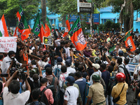 Bharatiya Janata Party (BJP) activists break the police barricade during a protest rally as they go towards the 'Swasthya Bhawan' or State H...