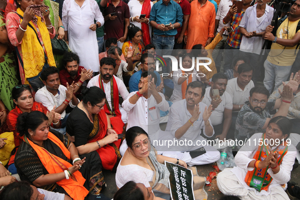 Bharatiya Janata Party's (BJP) Locket Chatterjee and BJP workers sit on the street near 'Swasthya Bhawan' or State Health & Family Welfare D...