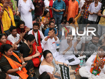 Bharatiya Janata Party's (BJP) Locket Chatterjee and BJP workers sit on the street near 'Swasthya Bhawan' or State Health & Family Welfare D...