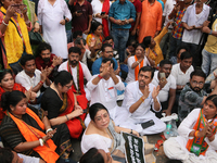 Bharatiya Janata Party's (BJP) Locket Chatterjee and BJP workers sit on the street near 'Swasthya Bhawan' or State Health & Family Welfare D...