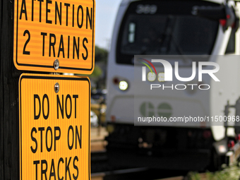 A commuter train heads toward a level crossing on the same rail corridor through the Brampton Innovation District that Canadian National Rai...