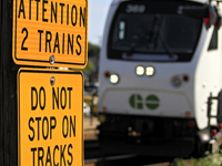 A commuter train heads toward a level crossing on the same rail corridor through the Brampton Innovation District that Canadian National Rai...