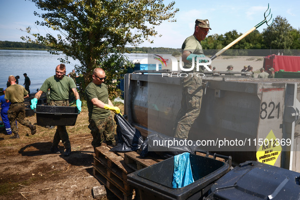 Members of Territorial Defence Force remove dead fishes from Lake Dzierzno Duze in Rzeczyce, southern Poland on August 20th, 2024. Since the...