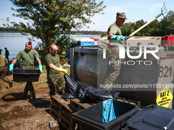 Members of Territorial Defence Force remove dead fishes from Lake Dzierzno Duze in Rzeczyce, southern Poland on August 20th, 2024. Since the...