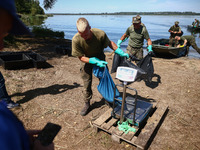 Members of Territorial Defence Force remove dead fishes from Lake Dzierzno Duze in Rzeczyce, southern Poland on August 20th, 2024. Since the...