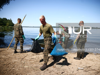 Members of Territorial Defence Force remove dead fishes from Lake Dzierzno Duze in Rzeczyce, southern Poland on August 20th, 2024. Since the...