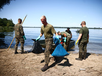 Members of Territorial Defence Force remove dead fishes from Lake Dzierzno Duze in Rzeczyce, southern Poland on August 20th, 2024. Since the...