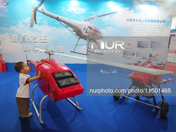 Visitors view an ''unmanned helicopter'' at the 2024 World Robot Conference in Beijing, China, on August 22, 2024. 