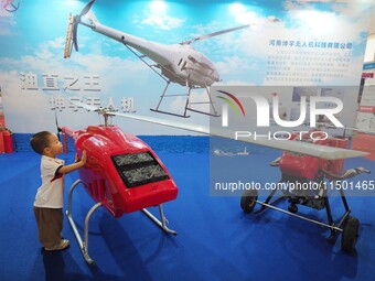 Visitors view an ''unmanned helicopter'' at the 2024 World Robot Conference in Beijing, China, on August 22, 2024. (