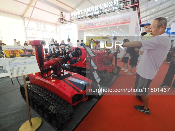 Visitors view a ''fire-fighting robot'' at the 2024 World Robot Conference in Beijing, China, on August 22, 2024. 