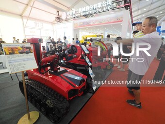 Visitors view a ''fire-fighting robot'' at the 2024 World Robot Conference in Beijing, China, on August 22, 2024. (