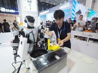 Visitors visit a ''stir-frying robot'' at the 2024 World Robot Conference in Beijing, China, on August 22, 2024. (