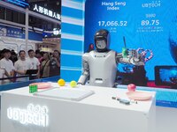 Visitors watch a robot grasping performance at the 2024 World Robot Conference in Beijing, China, on August 22, 2024. (